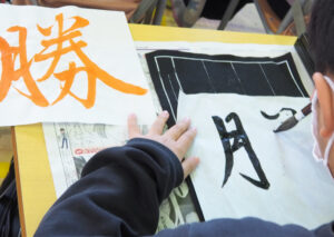 茂住さんが全員分用意した「朱書き」での文字を参考に子どもたちが各自決めた「未来の一字」を記していた